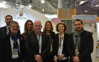 L'image représente l'ensemble de l'équipe APART'âges debout devant leur stand au salon des Maires et des collectivités locales 2022. APART'âges est une entreprise proposant une solution d'habitat partagé inclusif pour seniors.